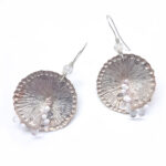 Large circular textured silver earrings with white and pink beaded detail