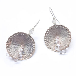 Large circular textured silver earrings with white and pink beaded detail